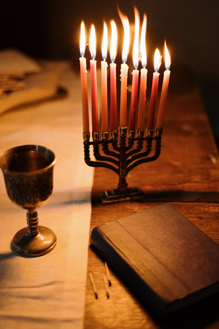 A beautifully lit menorah and traditional items for a cozy Hanukkah ambiance.